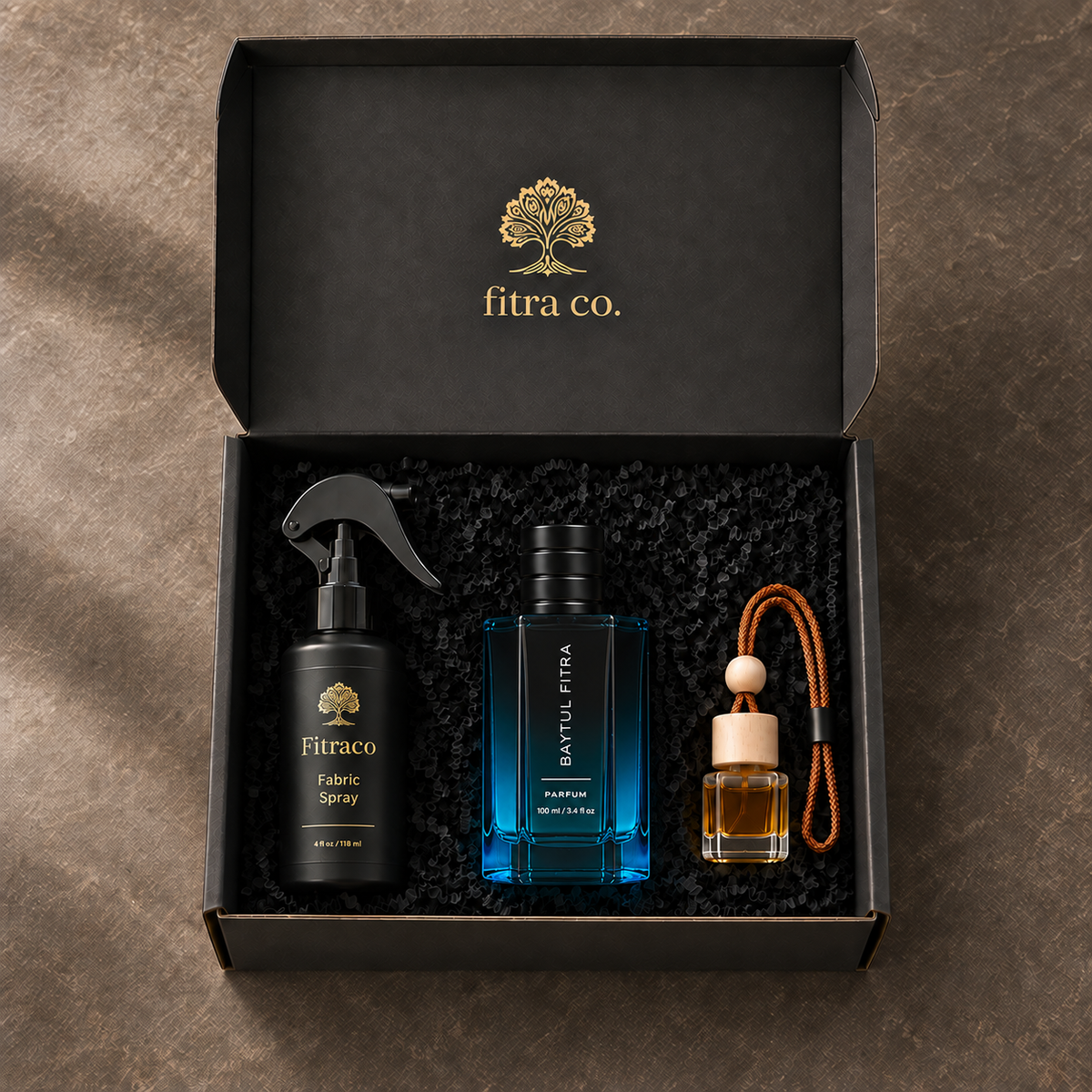 Three Essentials Gift Set products clearly displayed inside the open branded gift box on dark stone.